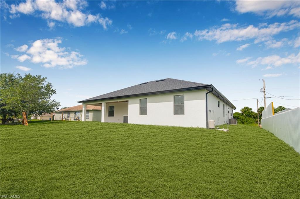 Rear view of house with a patio and stucco siding