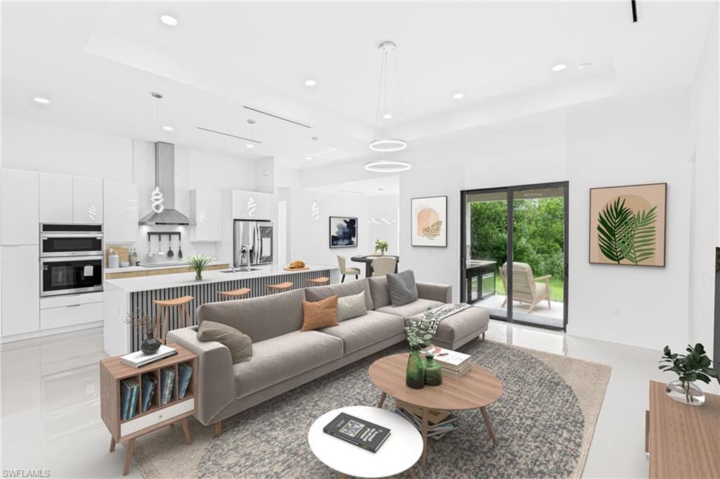 Living area featuring recessed lighting and a high tray ceiling