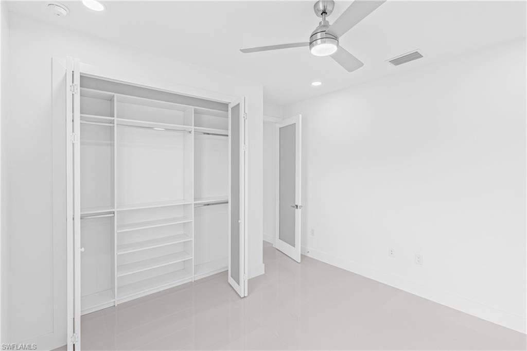 Unfurnished bedroom featuring recessed lighting, a ceiling fan, a closet, and concrete floors
