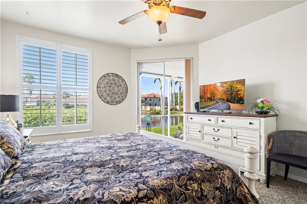 Primary bedroom has access to your lanai. Plantation shutters. Carpet in bedroom.