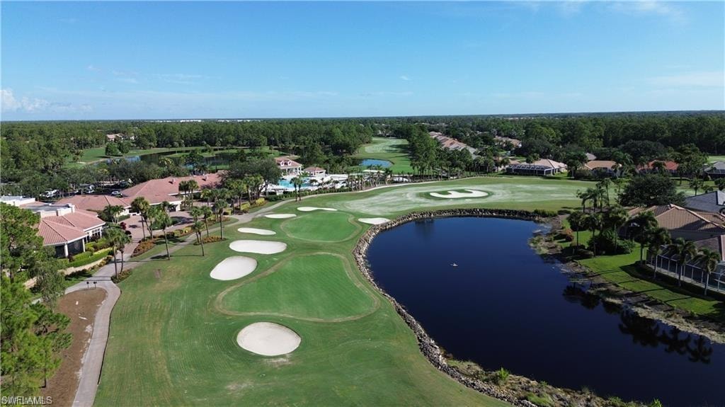 View of property location with a golf club, a large body of water, and nearby suburban area