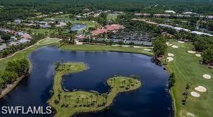 Aerial view of property and surrounding area with a large body of water and a golf club