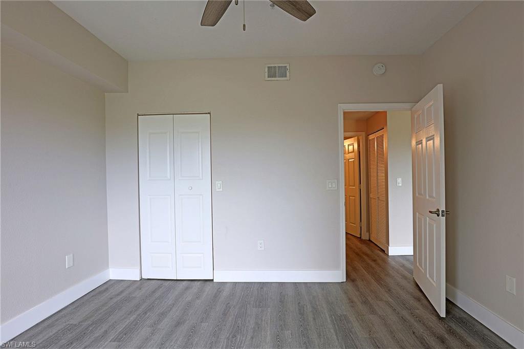 Unfurnished bedroom with wood finished floors, a closet, and ceiling fan