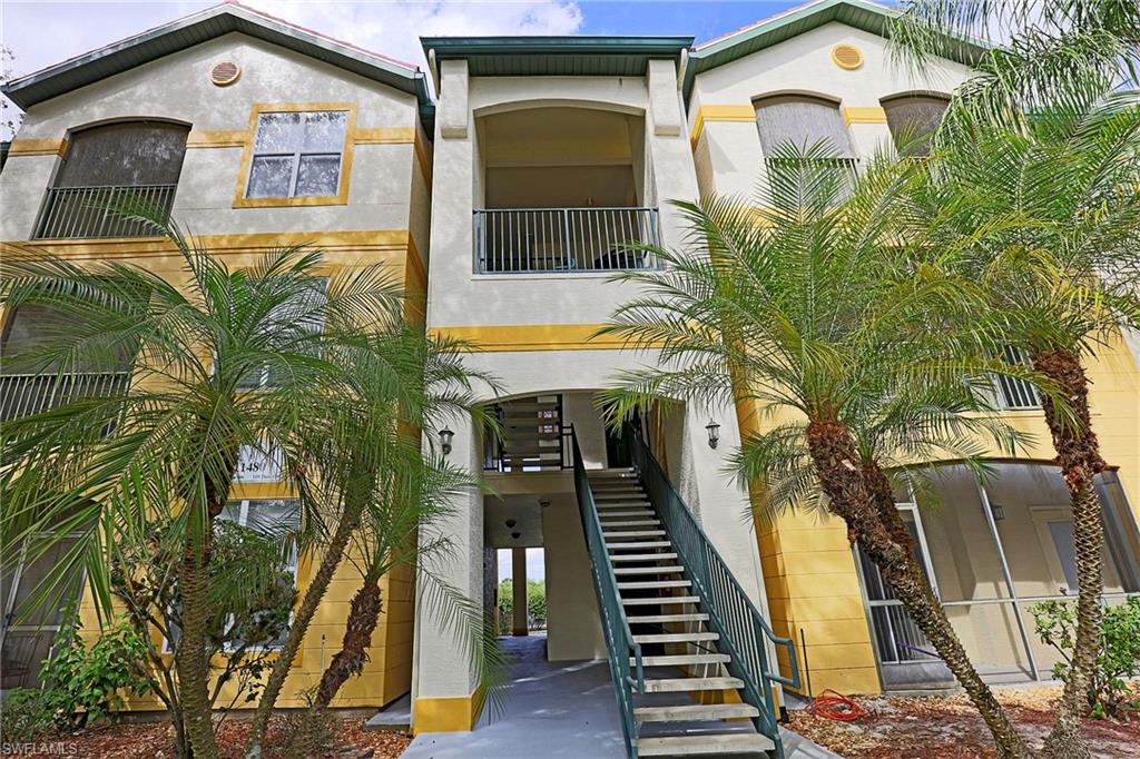 View of front of home featuring a balcony and stucco siding