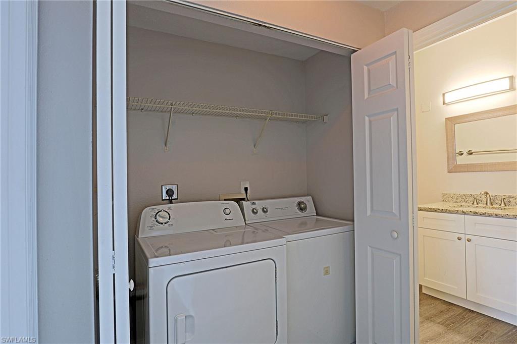 Laundry area featuring washer and clothes dryer and light wood-style flooring
