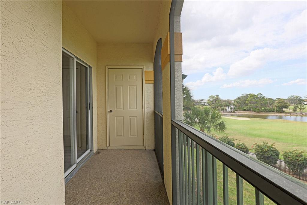 Balcony with a water view and golf course view