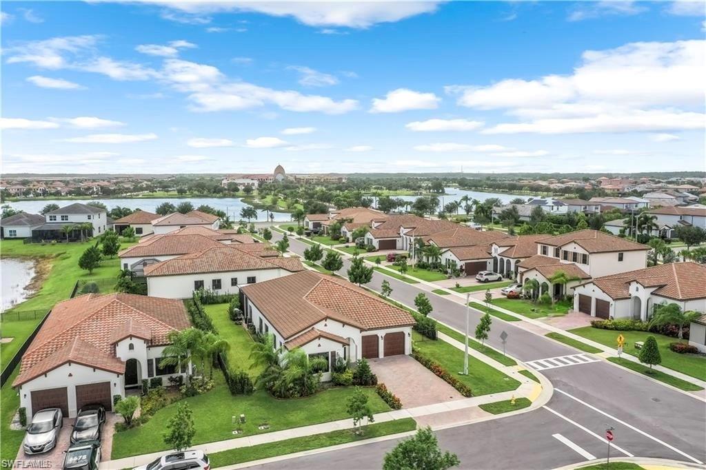 Aerial perspective of suburban area featuring a nearby body of water