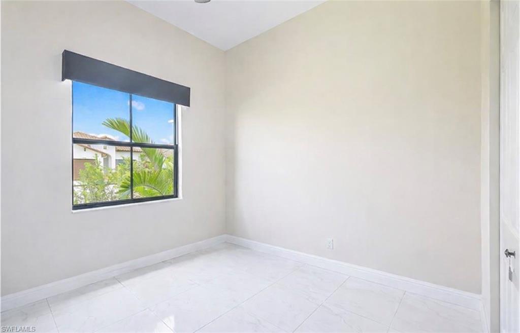 Empty room featuring baseboards