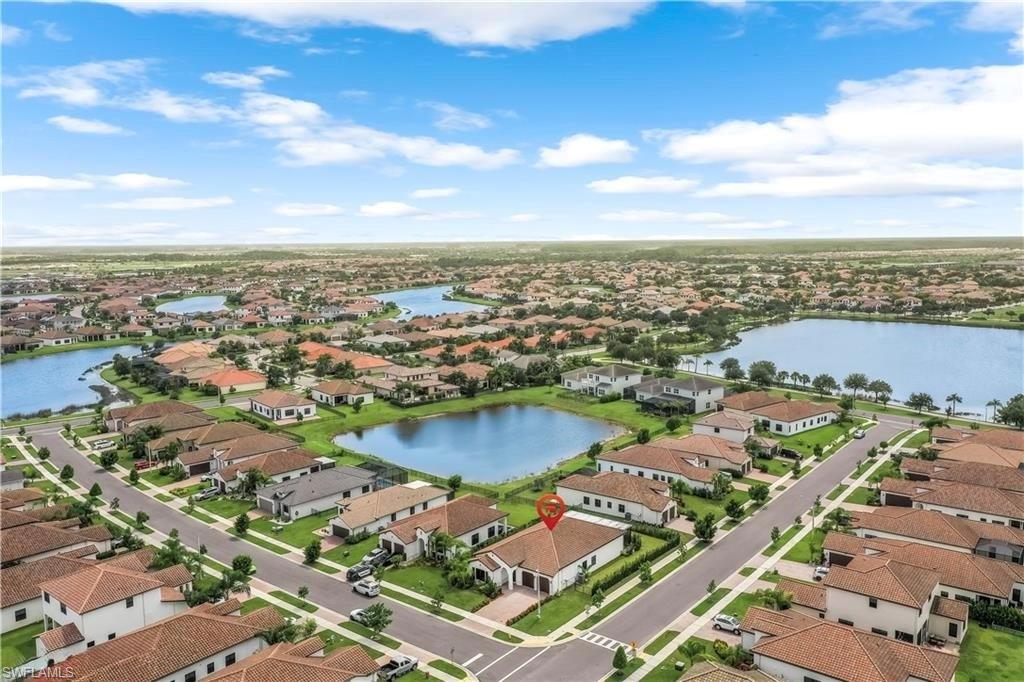 Aerial view of residential area featuring a nearby body of water