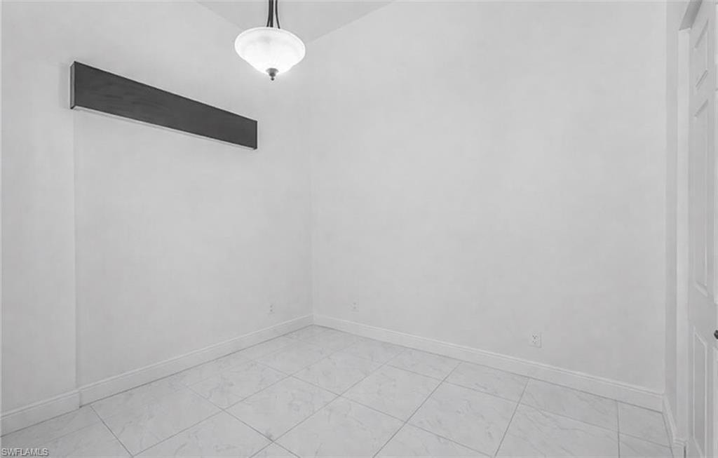 Empty room featuring baseboards