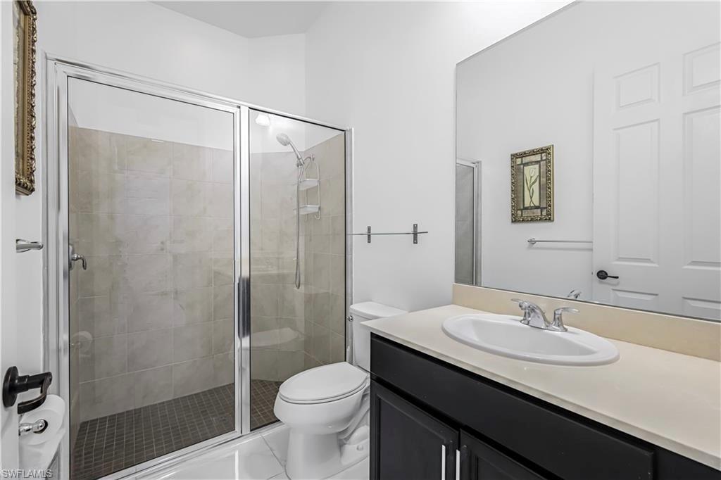 Bathroom featuring vanity and a shower stall