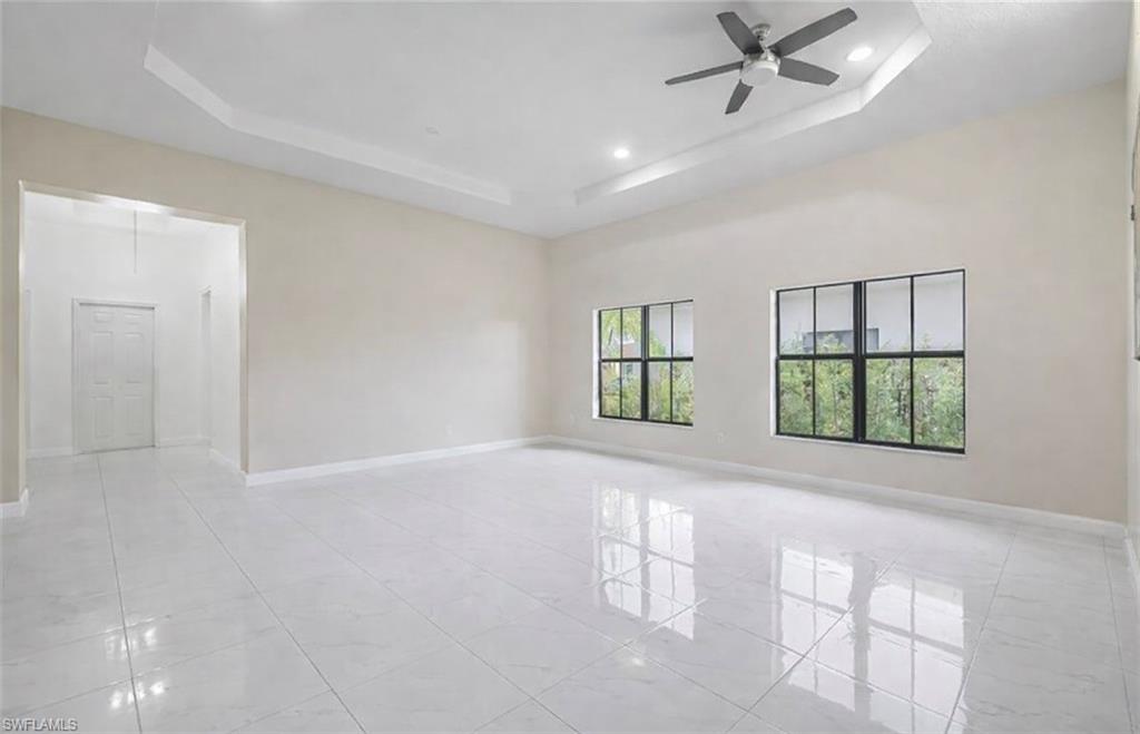 Spare room featuring ceiling fan, a tray ceiling, and recessed lighting