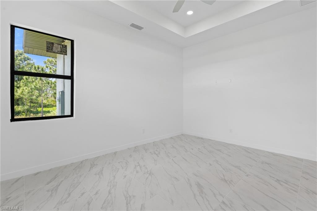 Spare room featuring recessed lighting, ceiling fan, and light marble finish flooring