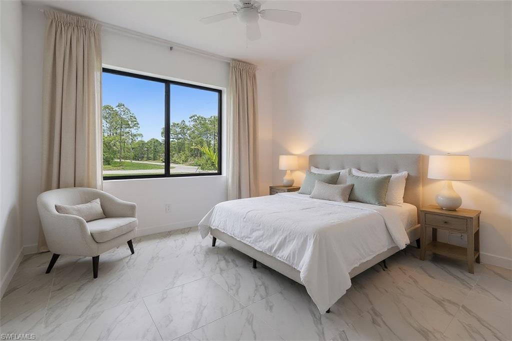 Bedroom with light marble finish flooring and a ceiling fan