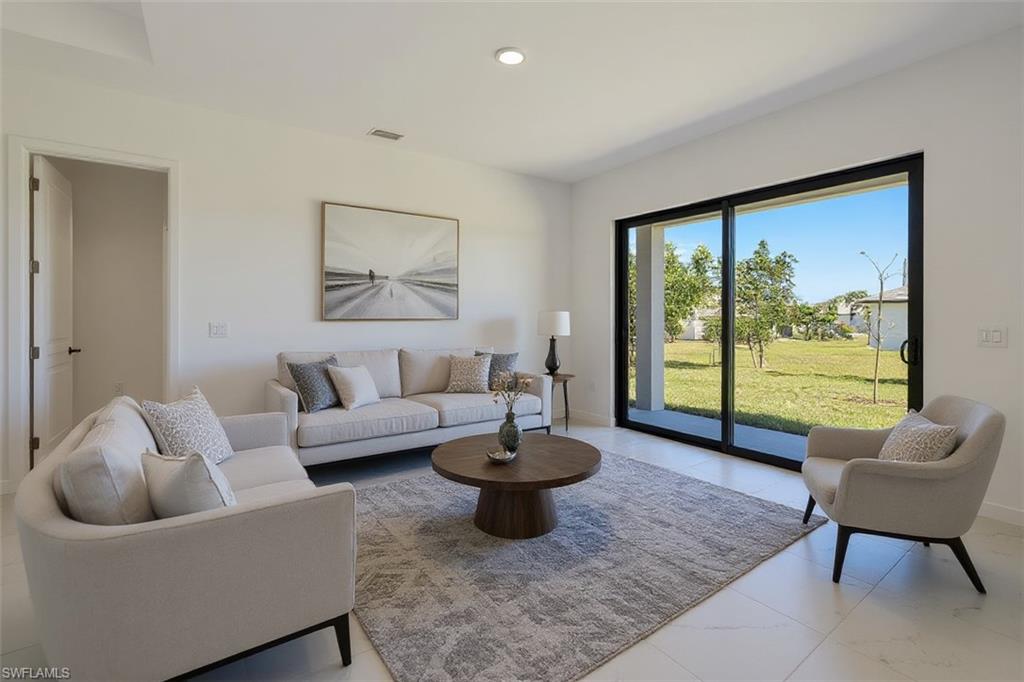 Living area featuring baseboards and recessed lighting