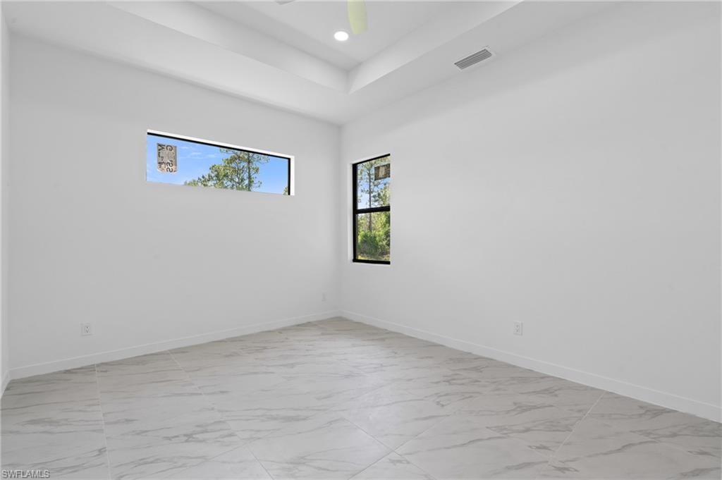 Spare room featuring light marble finish flooring and recessed lighting