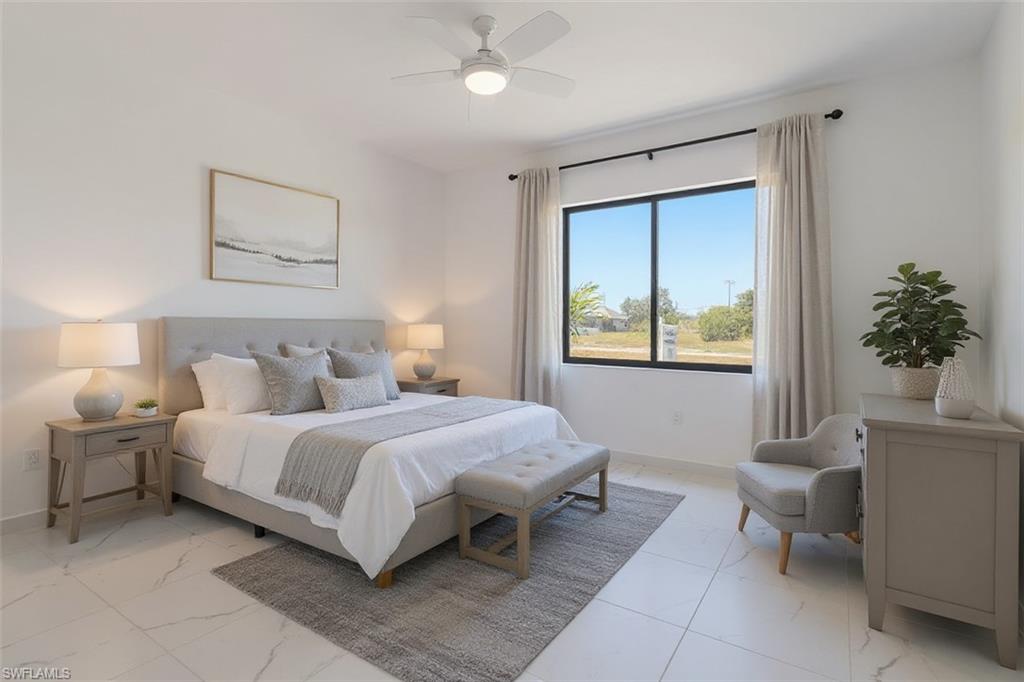 Bedroom with ceiling fan and light marble finish flooring