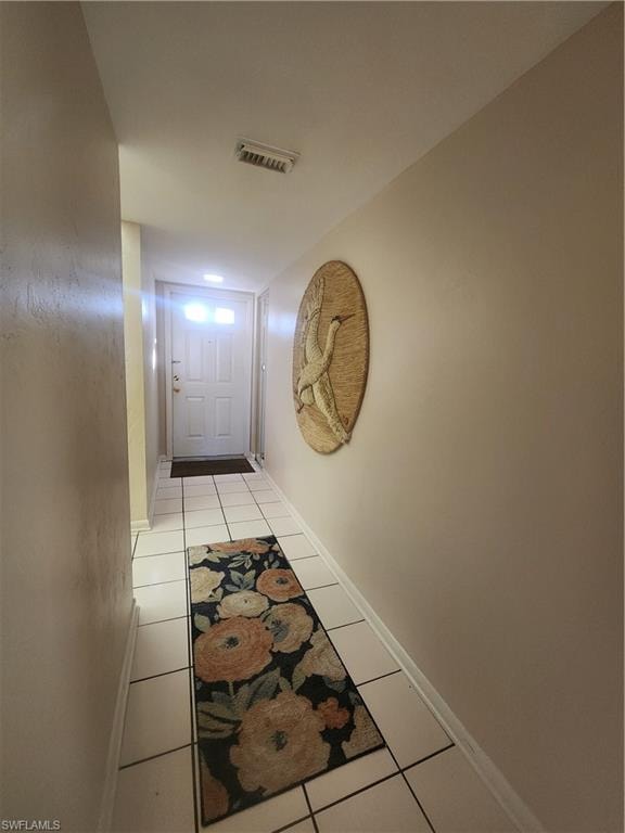 Corridor with light tile patterned floors
