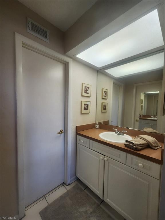 Bathroom with vanity and light tile patterned floors