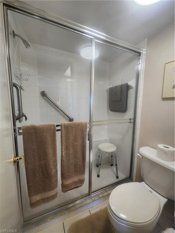 Full bath with a shower stall and toilet