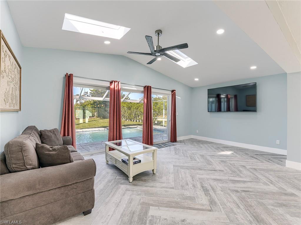 Den with acess to pool, vaulted ceiling