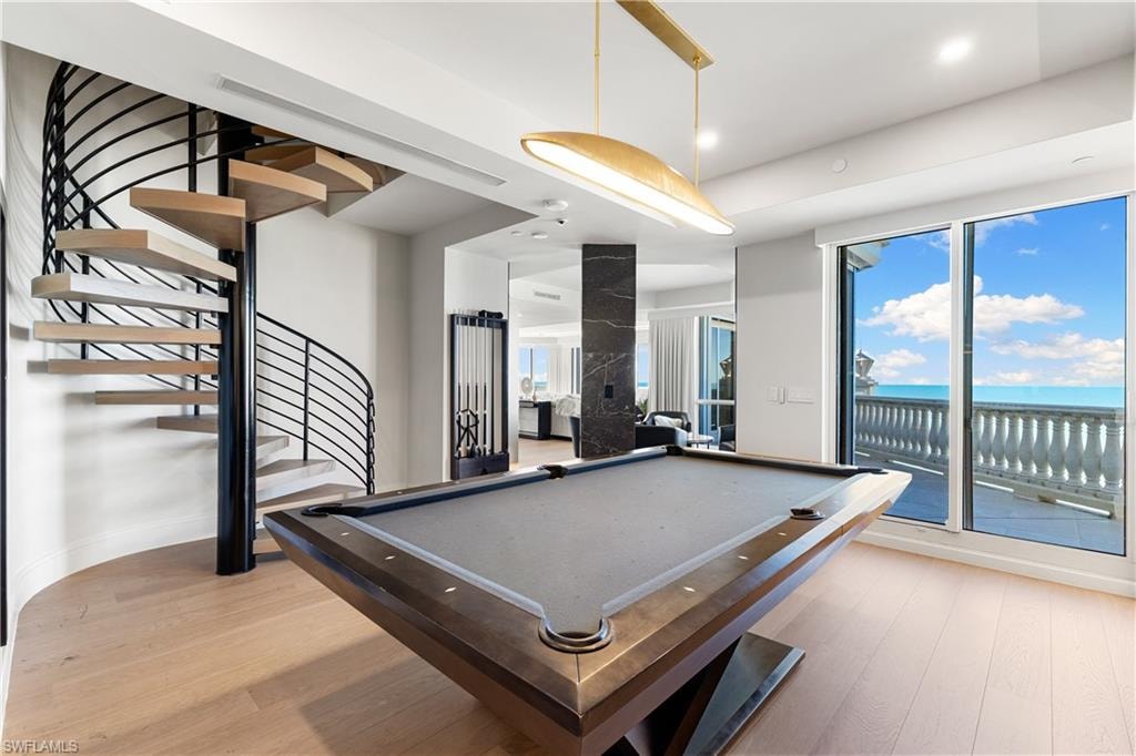 Playroom featuring billiards table, light wood-style floors, a water view, and recessed lighting