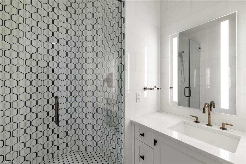 Full bath with a stall shower and vanity
