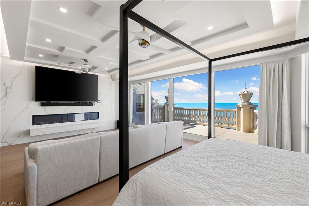 Bedroom with coffered ceiling, recessed lighting, access to outside, and light wood-style flooring