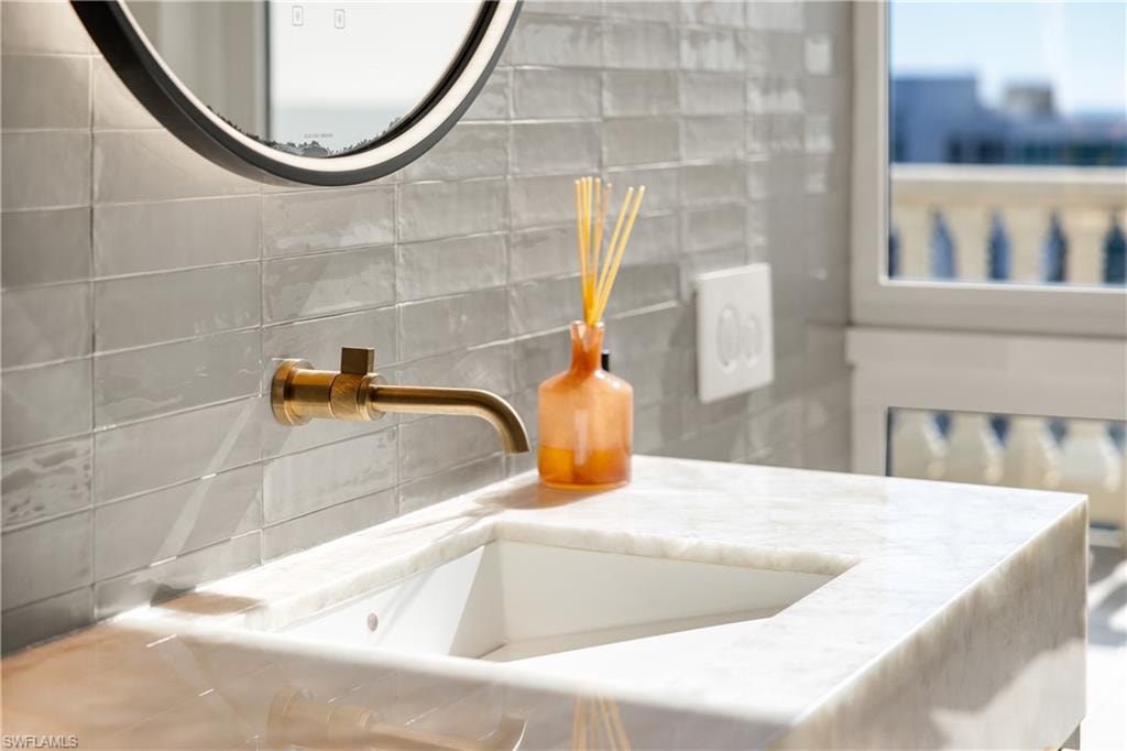 Detailed view of a sink and tasteful backsplash