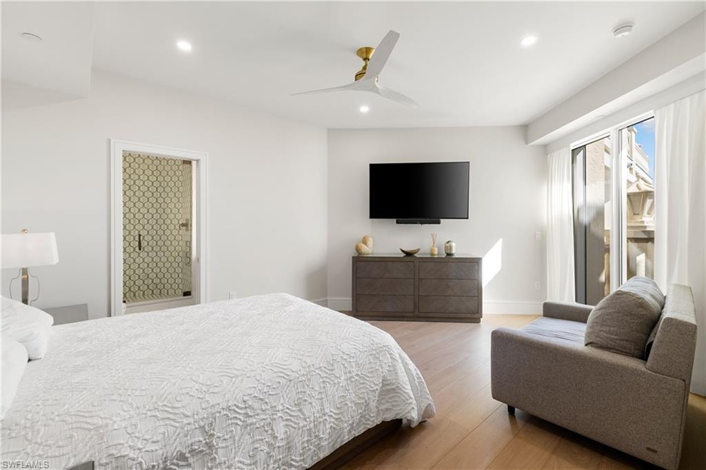 Bedroom with light wood-style flooring, ceiling fan, and recessed lighting