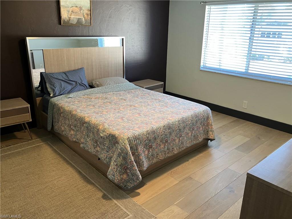 Bedroom featuring light wood finished floors and baseboards
