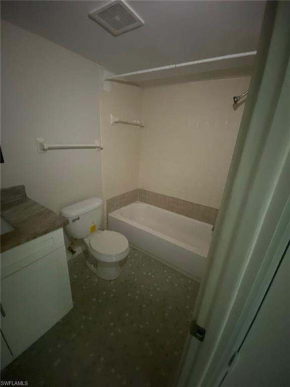 Full bathroom with washtub / shower combination and vanity