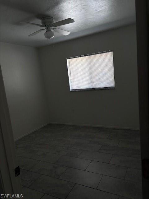 Spare room with ceiling fan and a textured ceiling