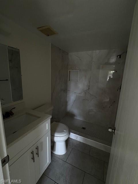 Bathroom with vanity, walk in shower, and tile patterned flooring