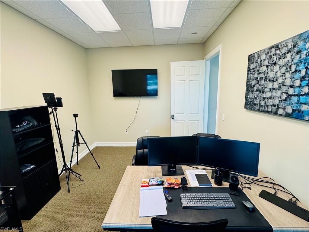 Office space with a paneled ceiling