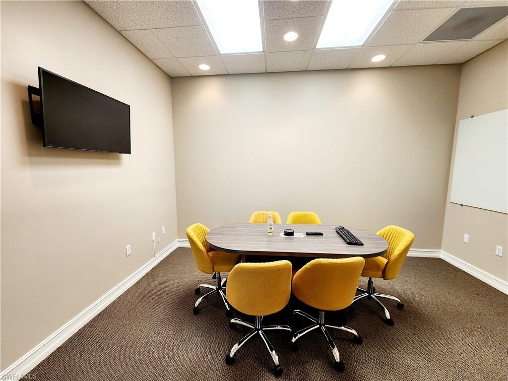 Dining space with a paneled ceiling, carpet flooring, and recessed lighting