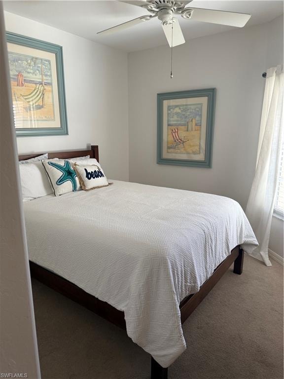 Carpeted bedroom with ceiling fan