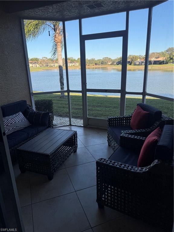 Sunroom / solarium featuring a water view