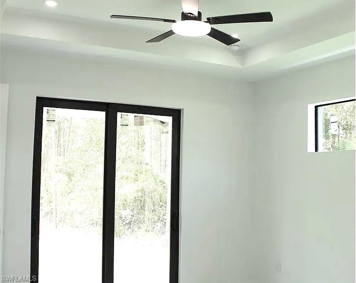Tray ceiling featuring a modern ceiling fan with integrated lighting and recessed lighting