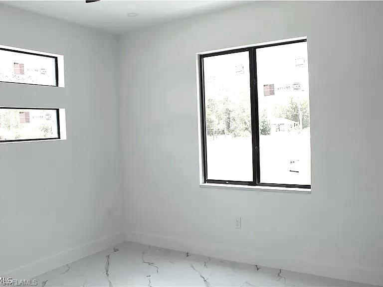Bright interior space featuring white walls and white baseboards