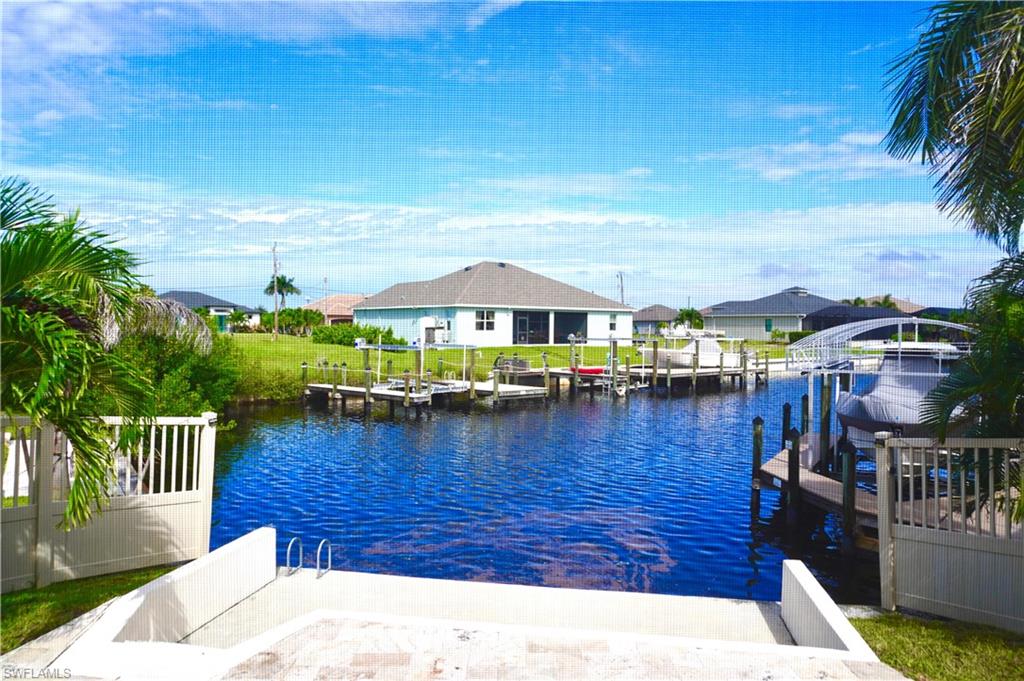 Dock with a water view and a residential view