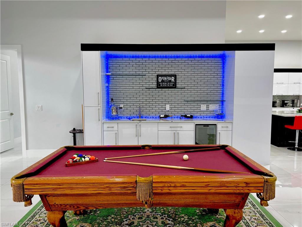Recreation room with wine cooler, light tile patterned floors, billiards table, and recessed lighting