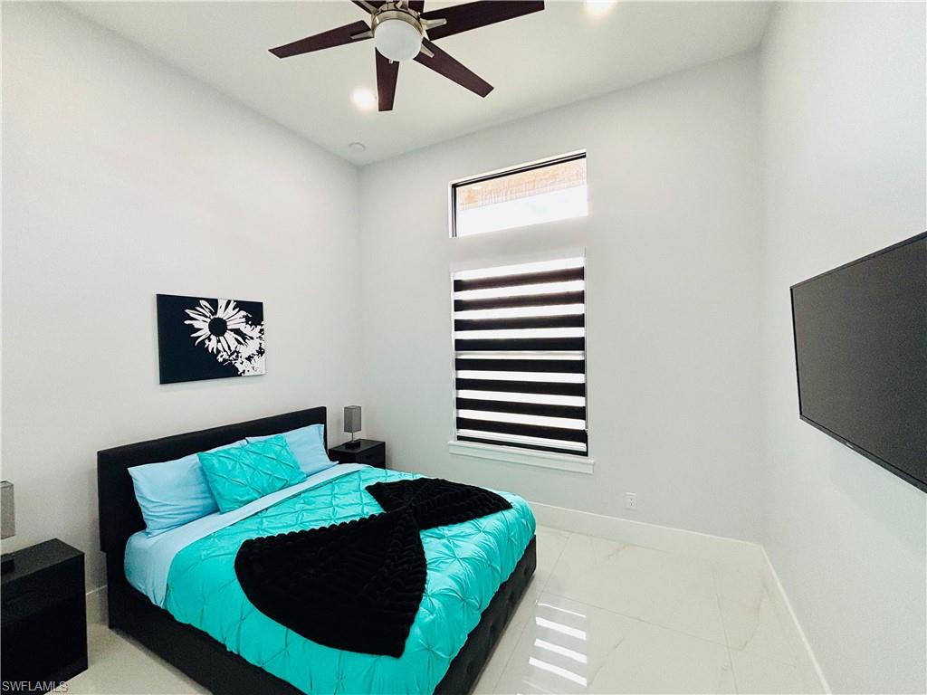Bedroom with a ceiling fan and recessed lighting