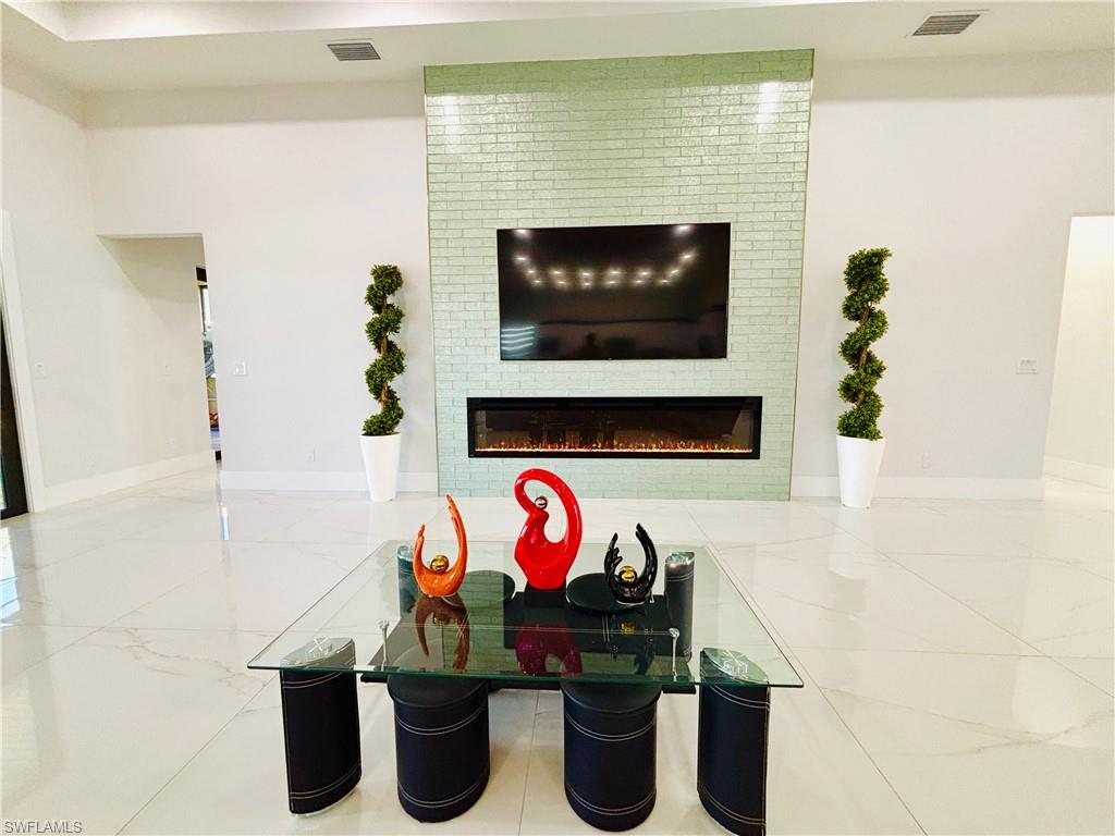 Detailed view of baseboards and a glass covered fireplace
