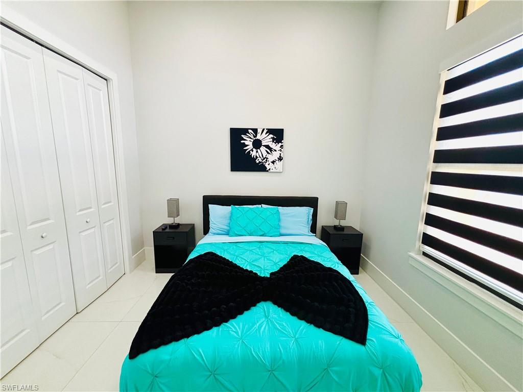 Bedroom featuring a closet and light tile patterned floors
