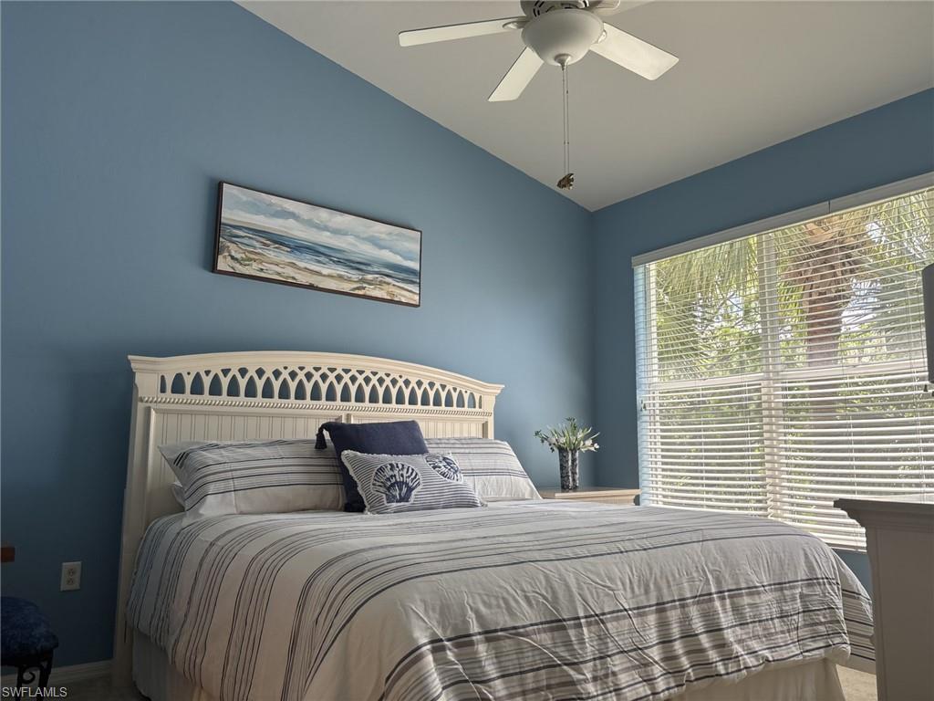 Bedroom featuring vaulted ceiling and a ceiling fan