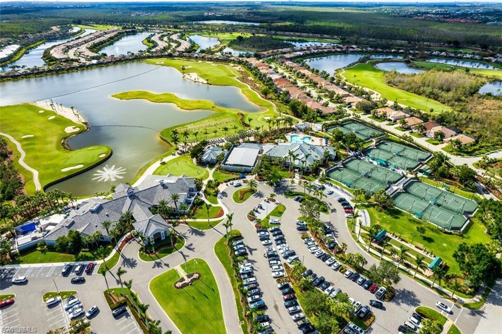 Aerial overview of property's location with a nearby body of water and a golf course
