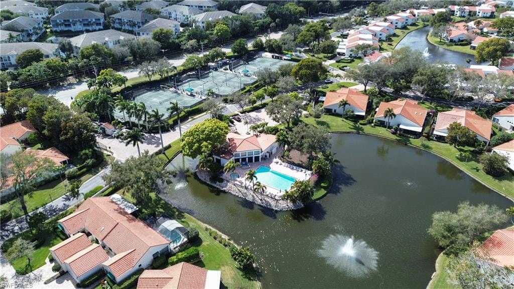 Aerial view of property and surrounding area with nearby suburban area and a nearby body of water
