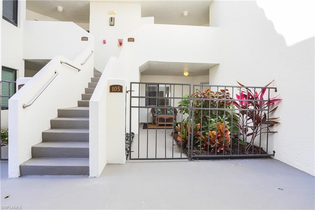 Stairs with finished concrete floors and a high ceiling