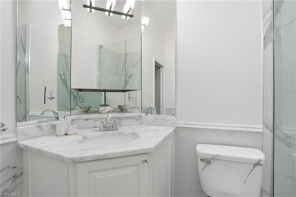 Guest bath with single vanity and custom marble finishes